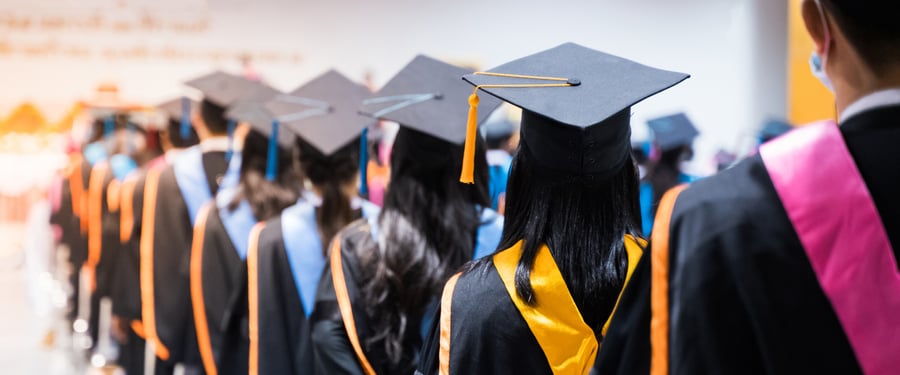 College graduates with colorful stoles standing in line