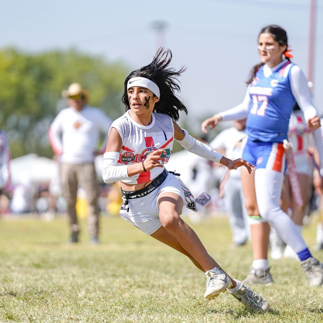 A female flag football player running