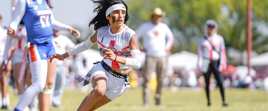 A female flag football player running